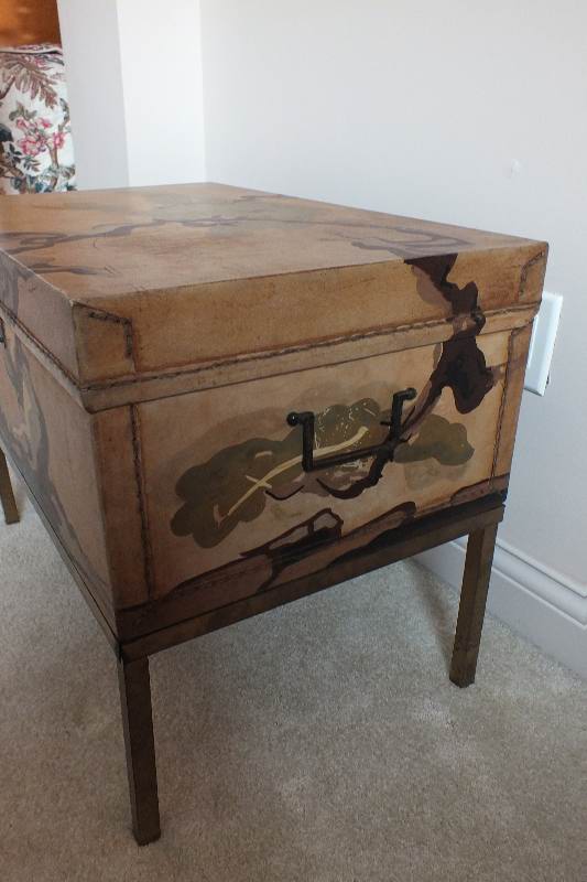 A painted leather like chest in the style of an Asian bride's trunk with two side handles