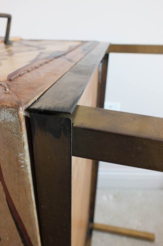 A painted leather like chest in the style of an Asian bride's trunk with two side handles