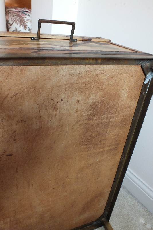 A painted leather like chest in the style of an Asian bride's trunk with two side handles