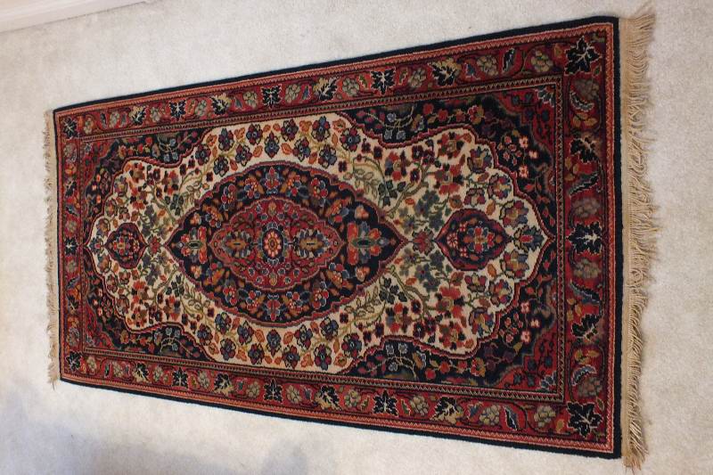 A semi antique hand woven wool and silk oriental style rug