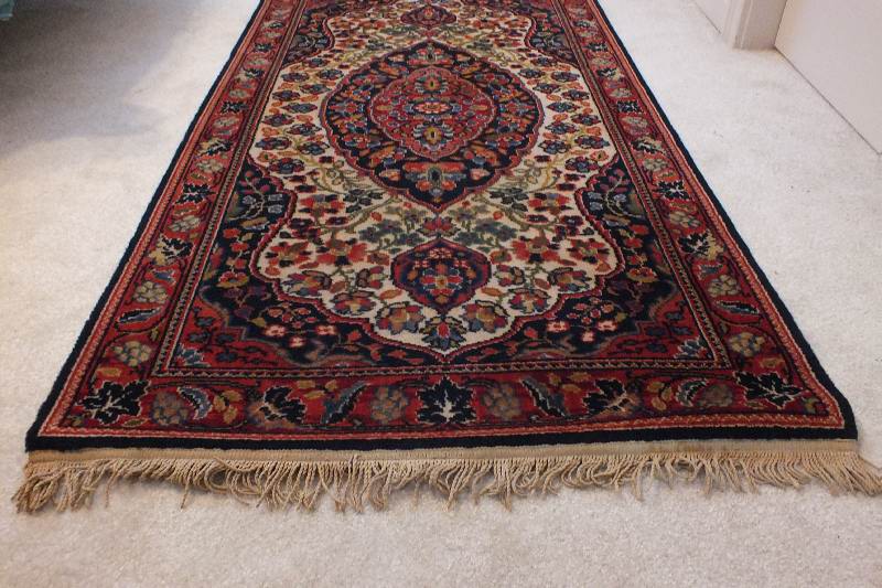 A semi antique hand woven wool and silk oriental style rug