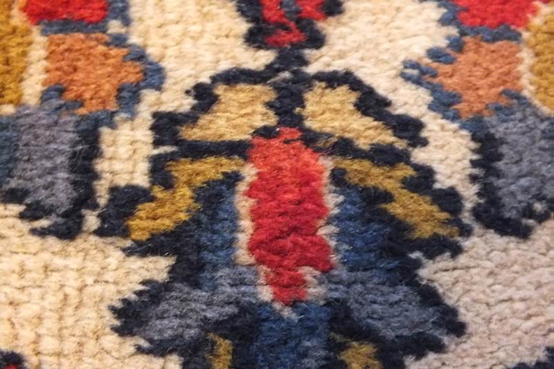 A semi antique hand woven wool and silk oriental style rug