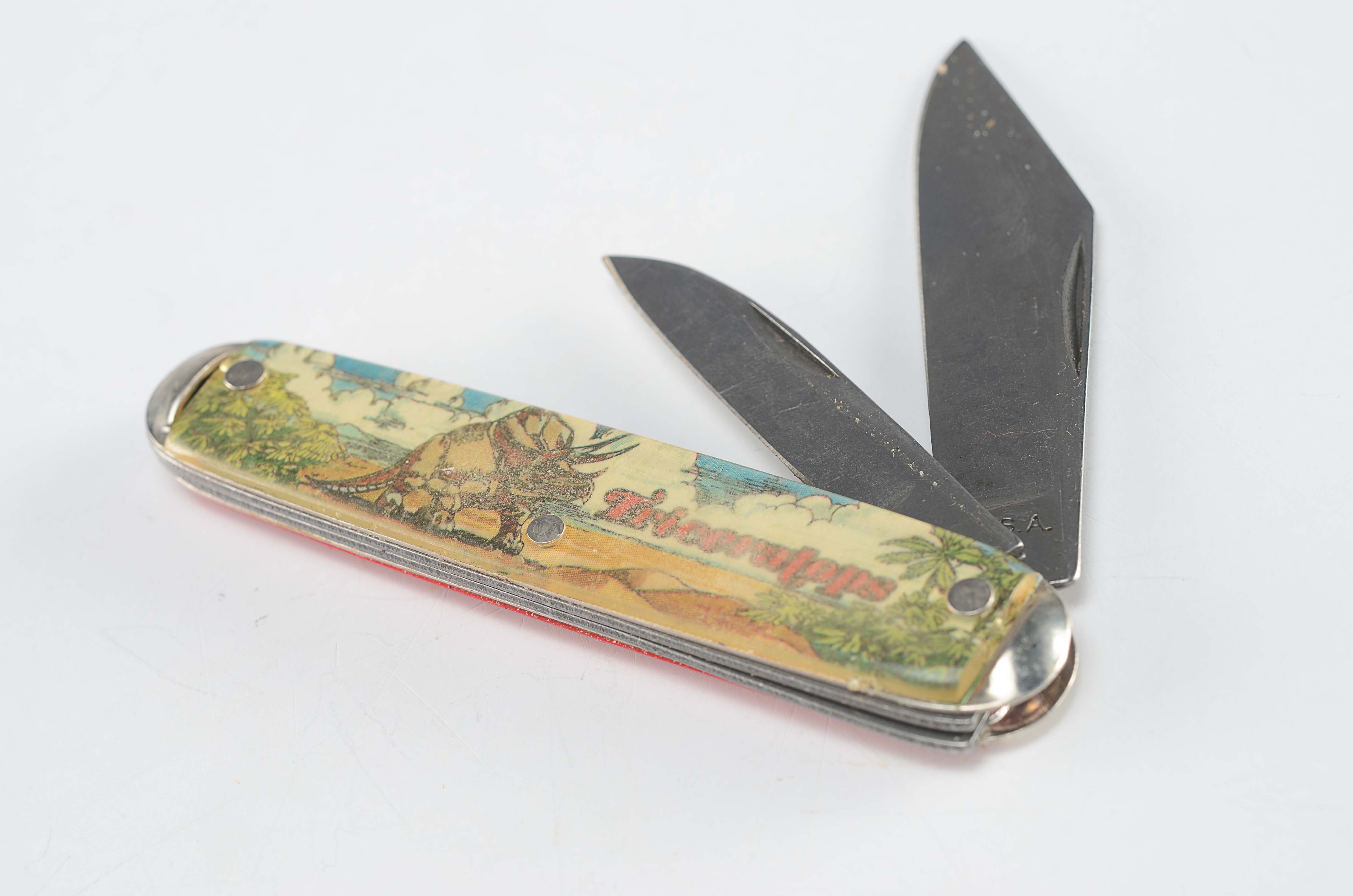 Dinosaur themed vintage pocket knives
