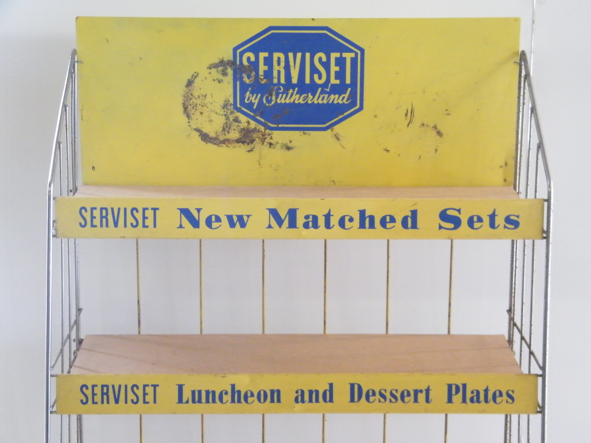 Vintage metal retail display shelf with advertisement