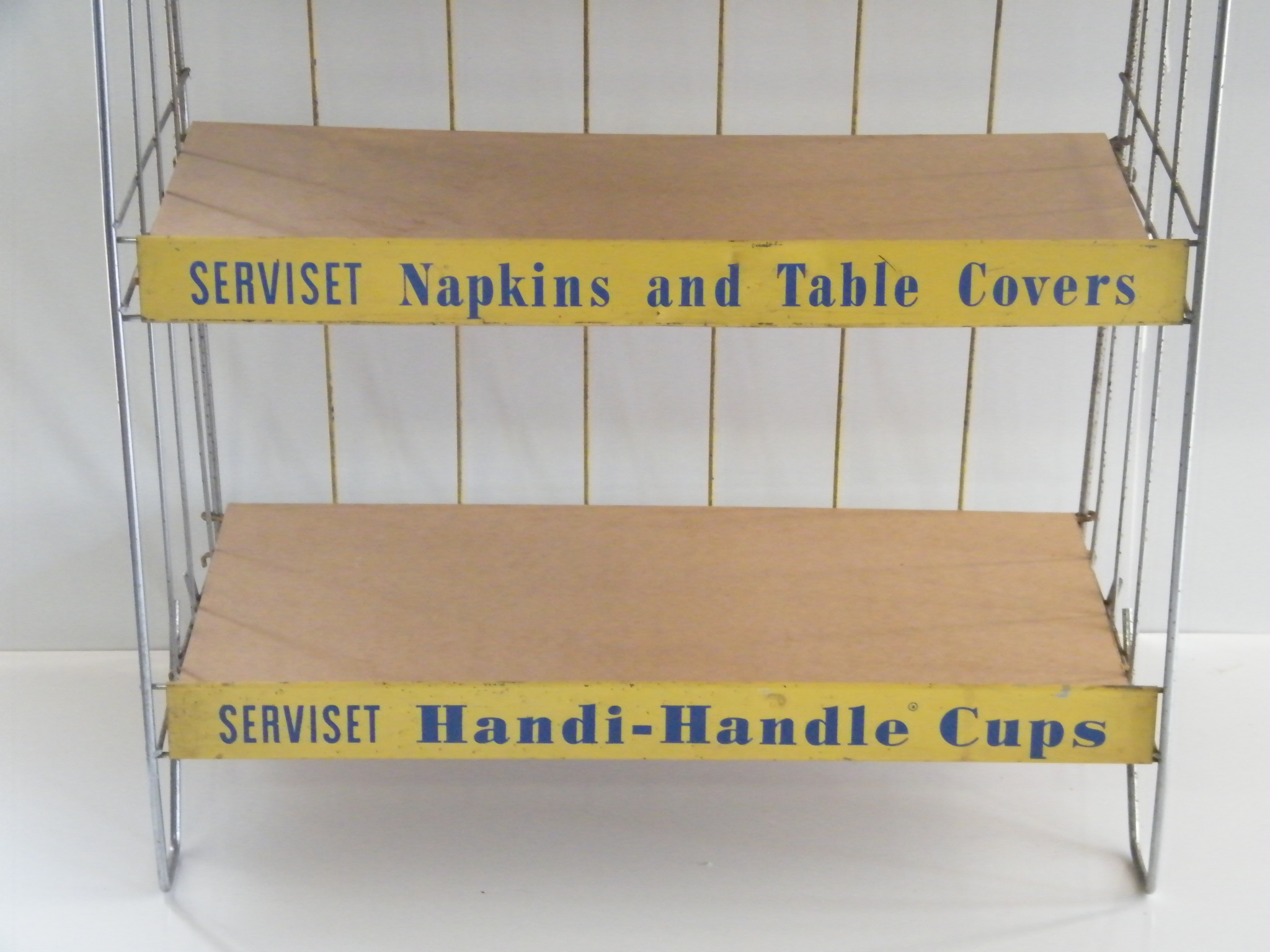 Vintage metal retail display shelf with advertisement