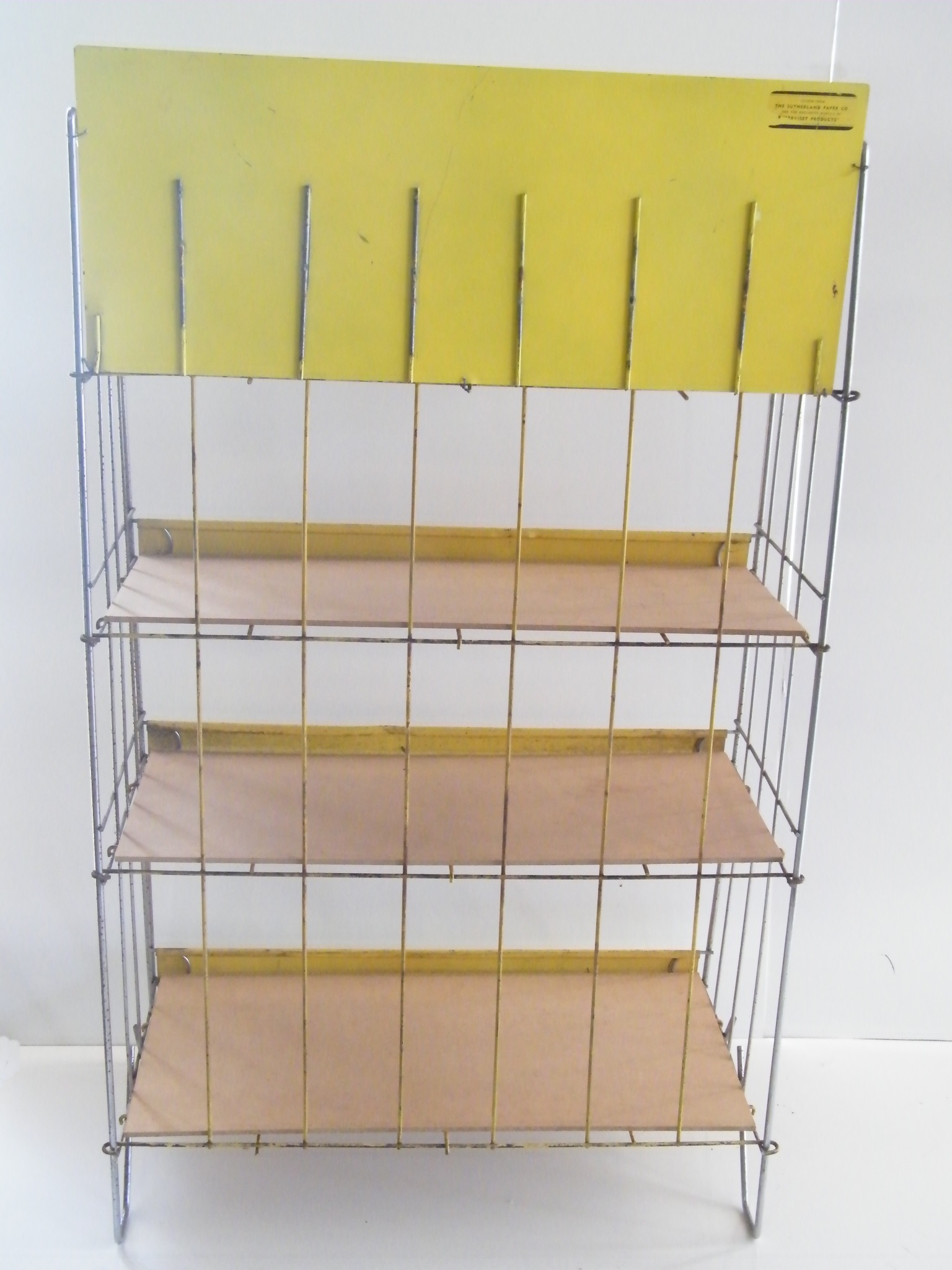 Vintage metal retail display shelf with advertisement