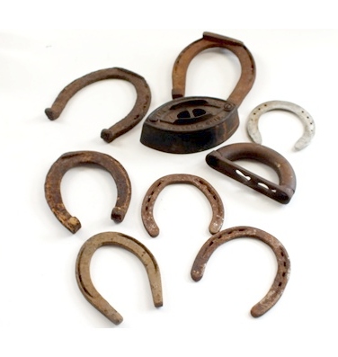 Vintage horse shoes and a A. C. Williams Co. sad iron