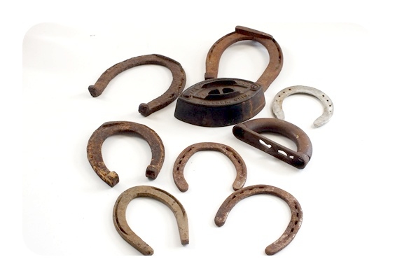 Vintage horse shoes and a A. C. Williams Co. sad iron