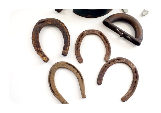 Vintage horse shoes and a A. C. Williams Co. sad iron