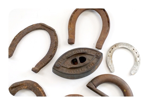 Vintage horse shoes and a A. C. Williams Co. sad iron