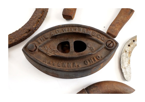Vintage horse shoes and a A. C. Williams Co. sad iron