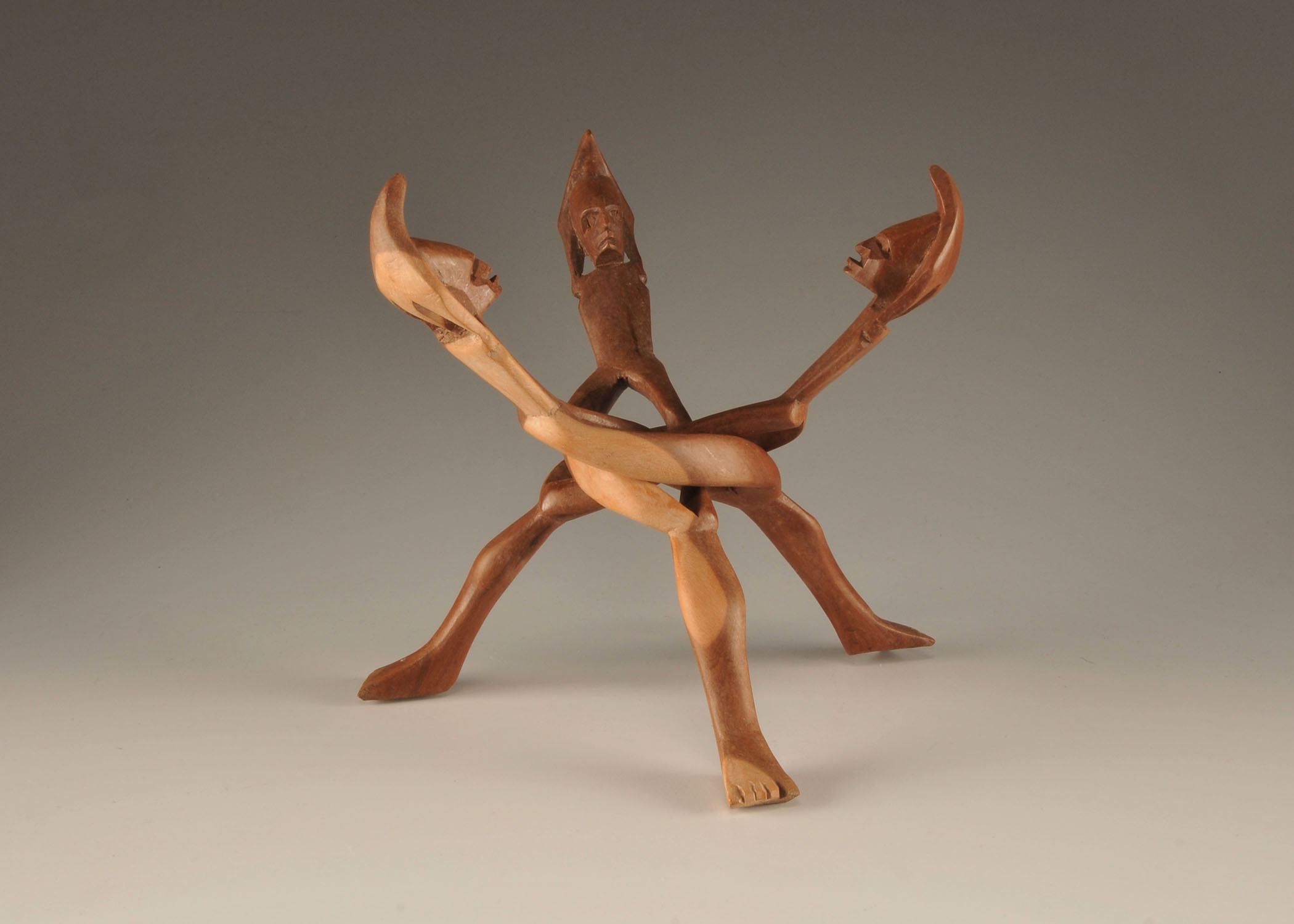  Vintage hand carved African "friends" sculpture of three intertwining figures with head dresses