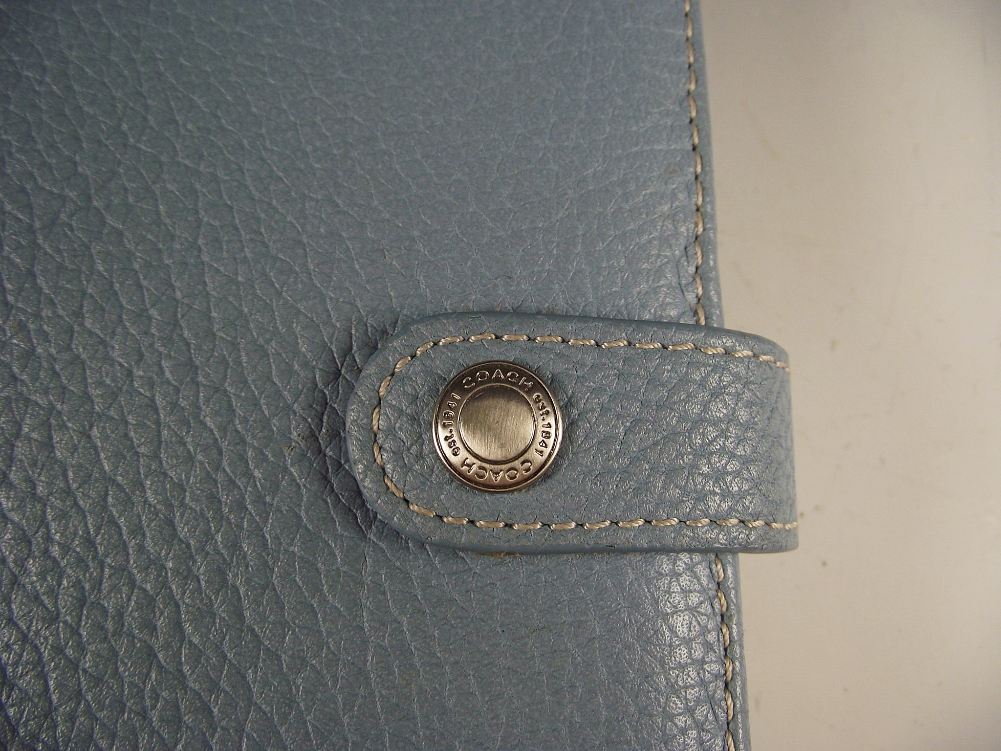 Fossil bracelet and Coach engagement book.