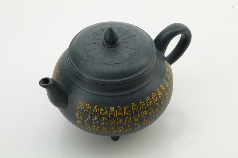 Modern Chinese Yixing earthenware teapot and a reproduction Chinese terra cotta "Standing Soldier" sculpture 