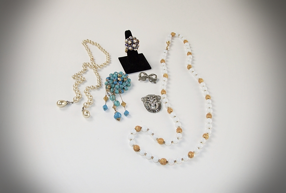 Collection of vintage costume jewelry including an Art Deco dress clip 