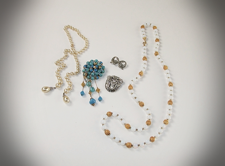 Collection of vintage costume jewelry including an Art Deco dress clip 