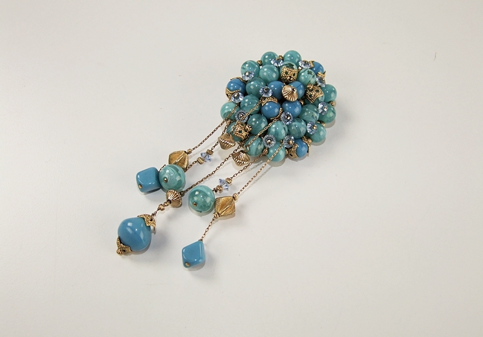 Collection of vintage costume jewelry including an Art Deco dress clip 