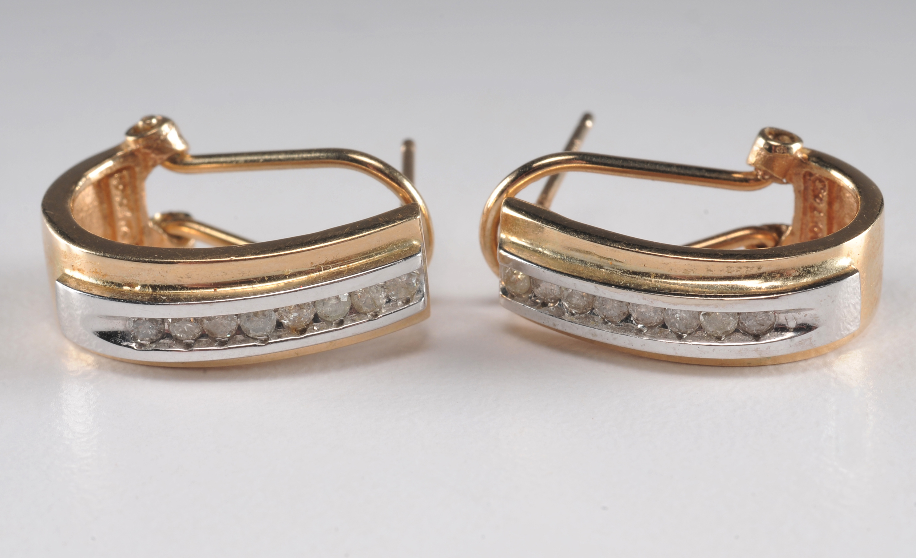 14 K yellow gold band with ruby and diamondsand a pair of 10 K two tone and diamond earrings