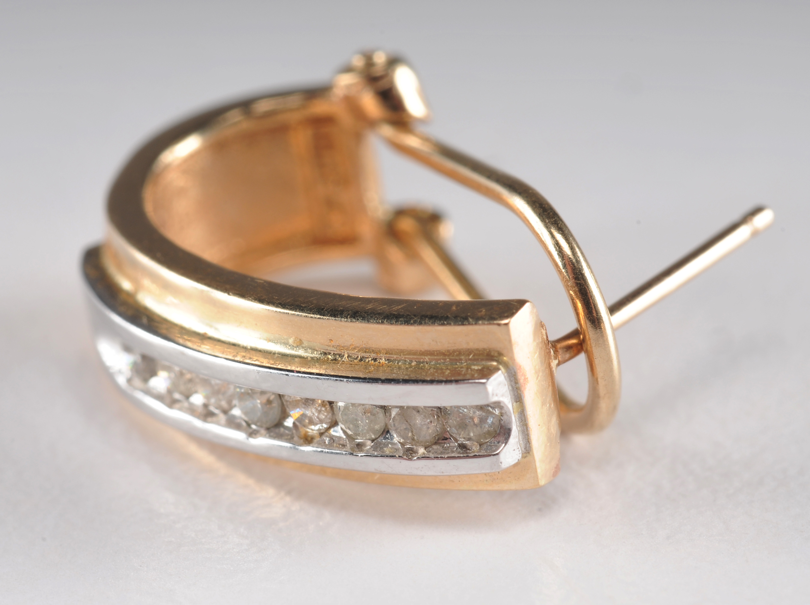 14 K yellow gold band with ruby and diamondsand a pair of 10 K two tone and diamond earrings