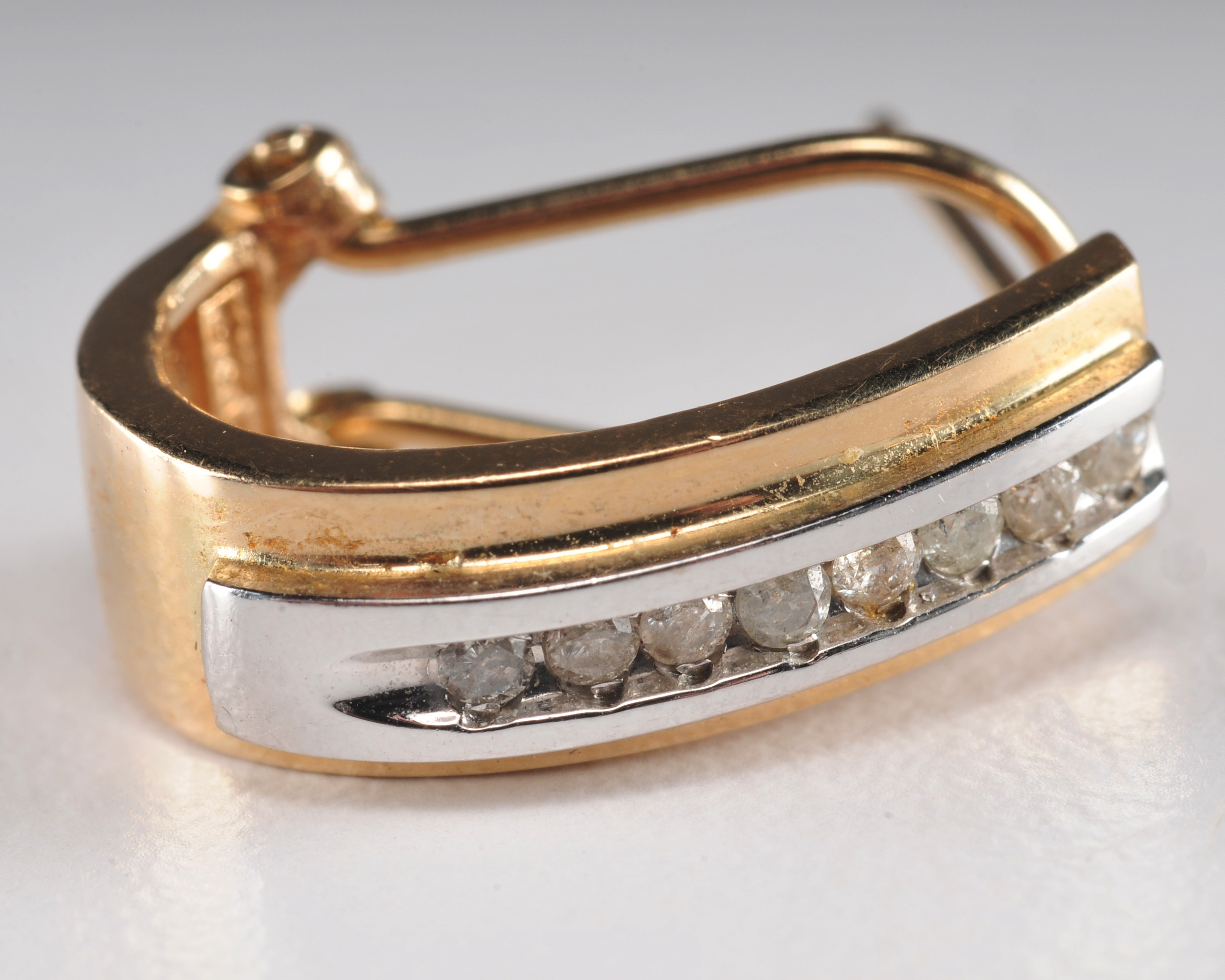 14 K yellow gold band with ruby and diamondsand a pair of 10 K two tone and diamond earrings