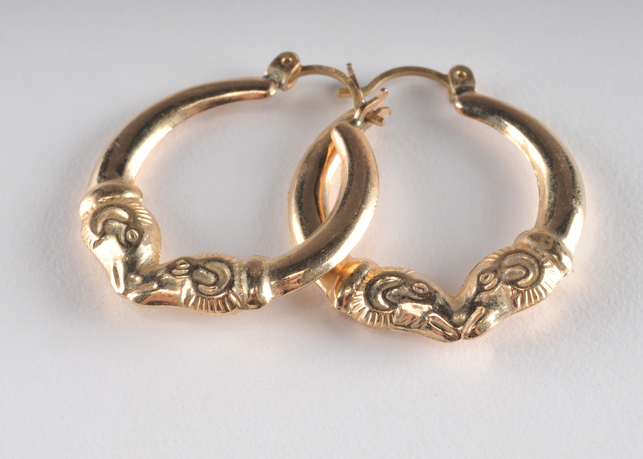 14 K yellow gold loop earrings with Rams head 