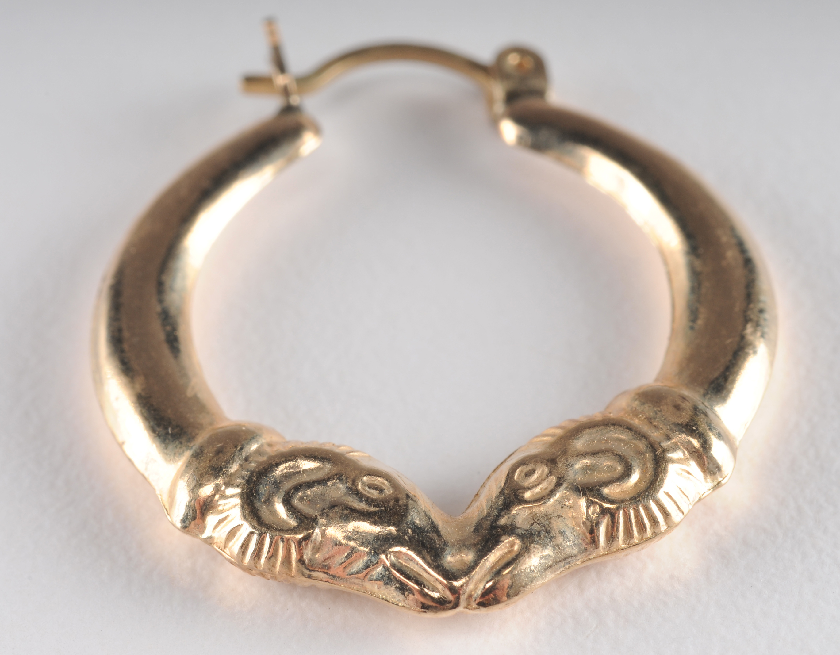 14 K yellow gold loop earrings with Rams head 