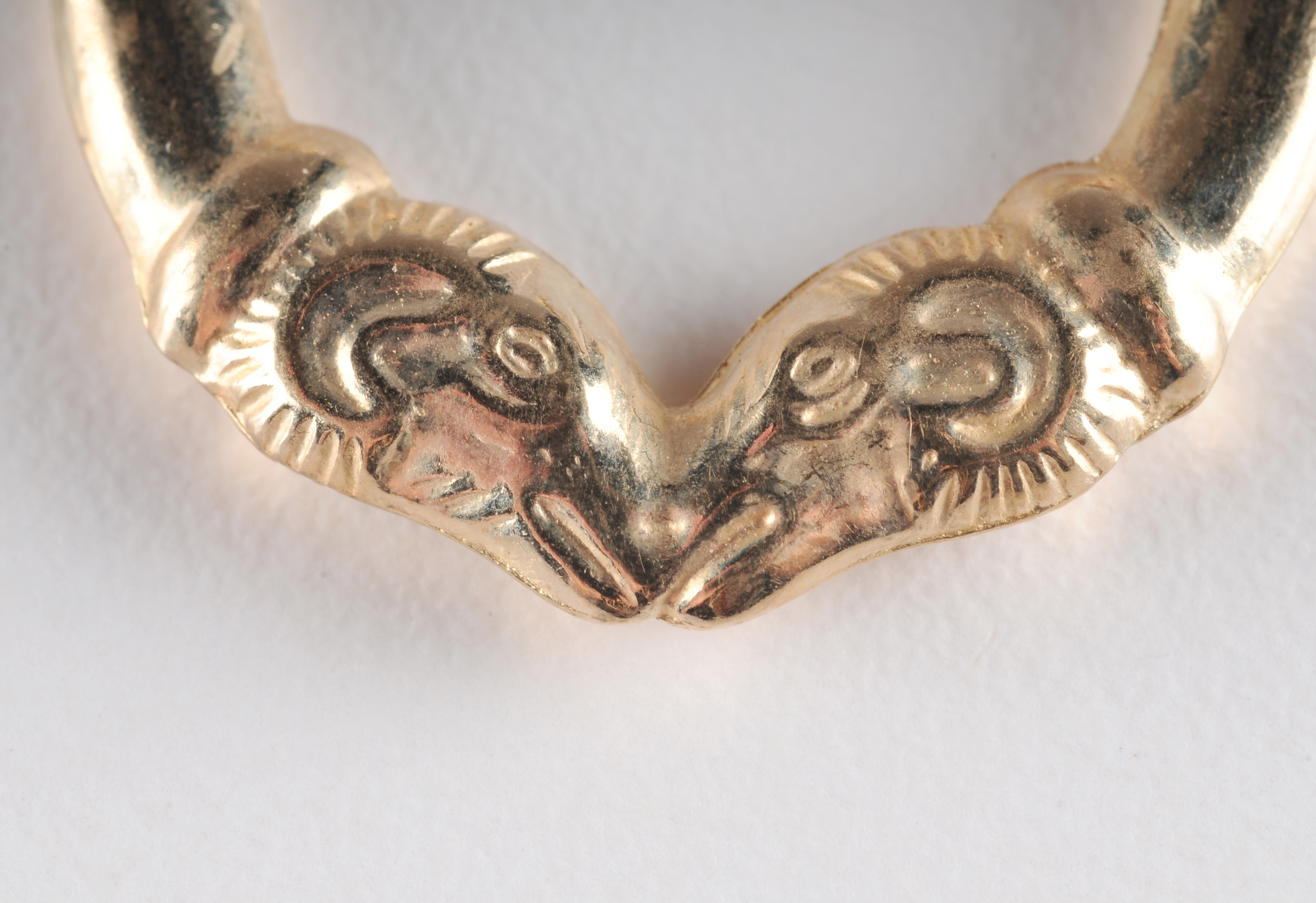 14 K yellow gold loop earrings with Rams head 