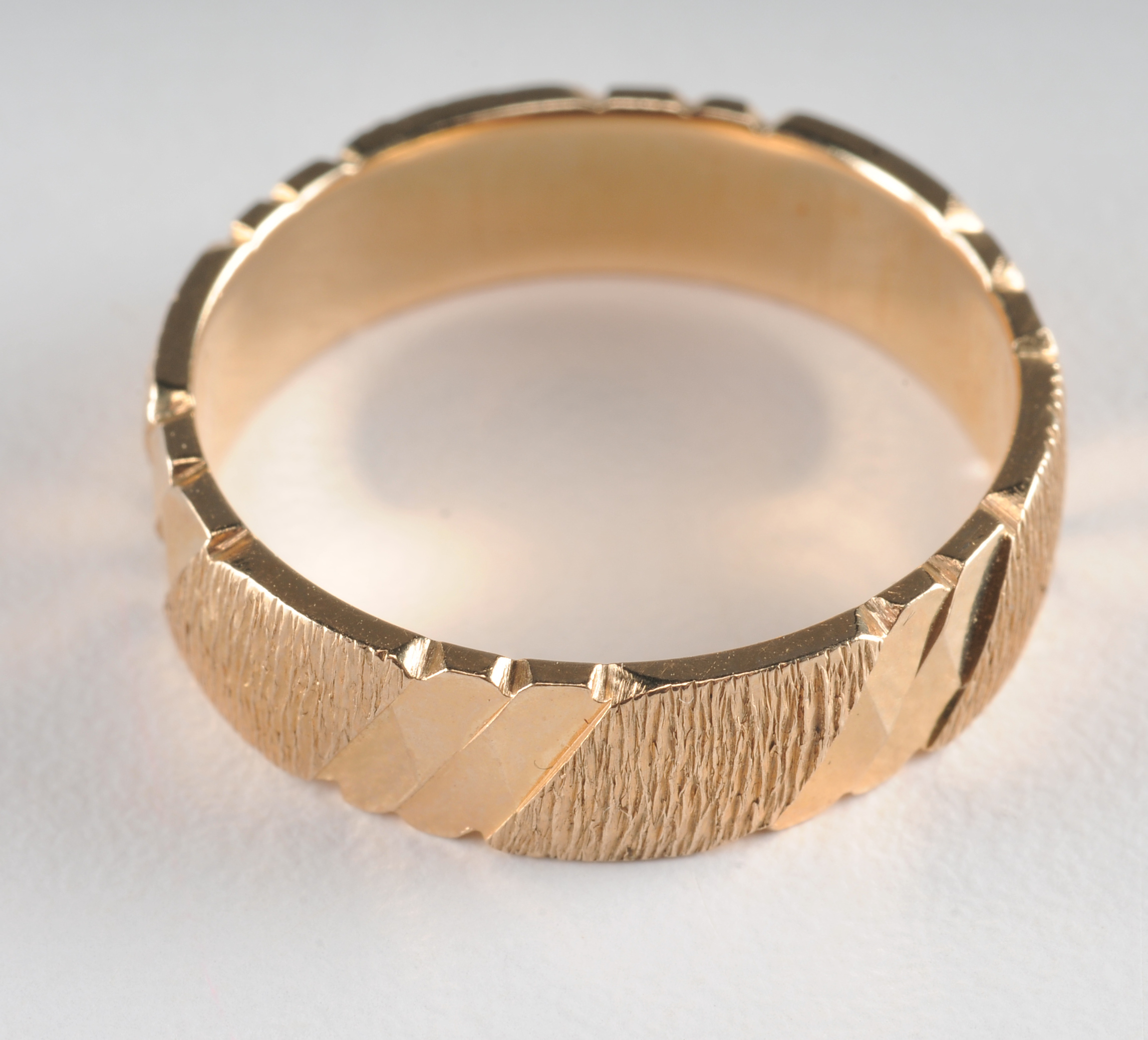 14 K yellow gold band with high polish bark design 