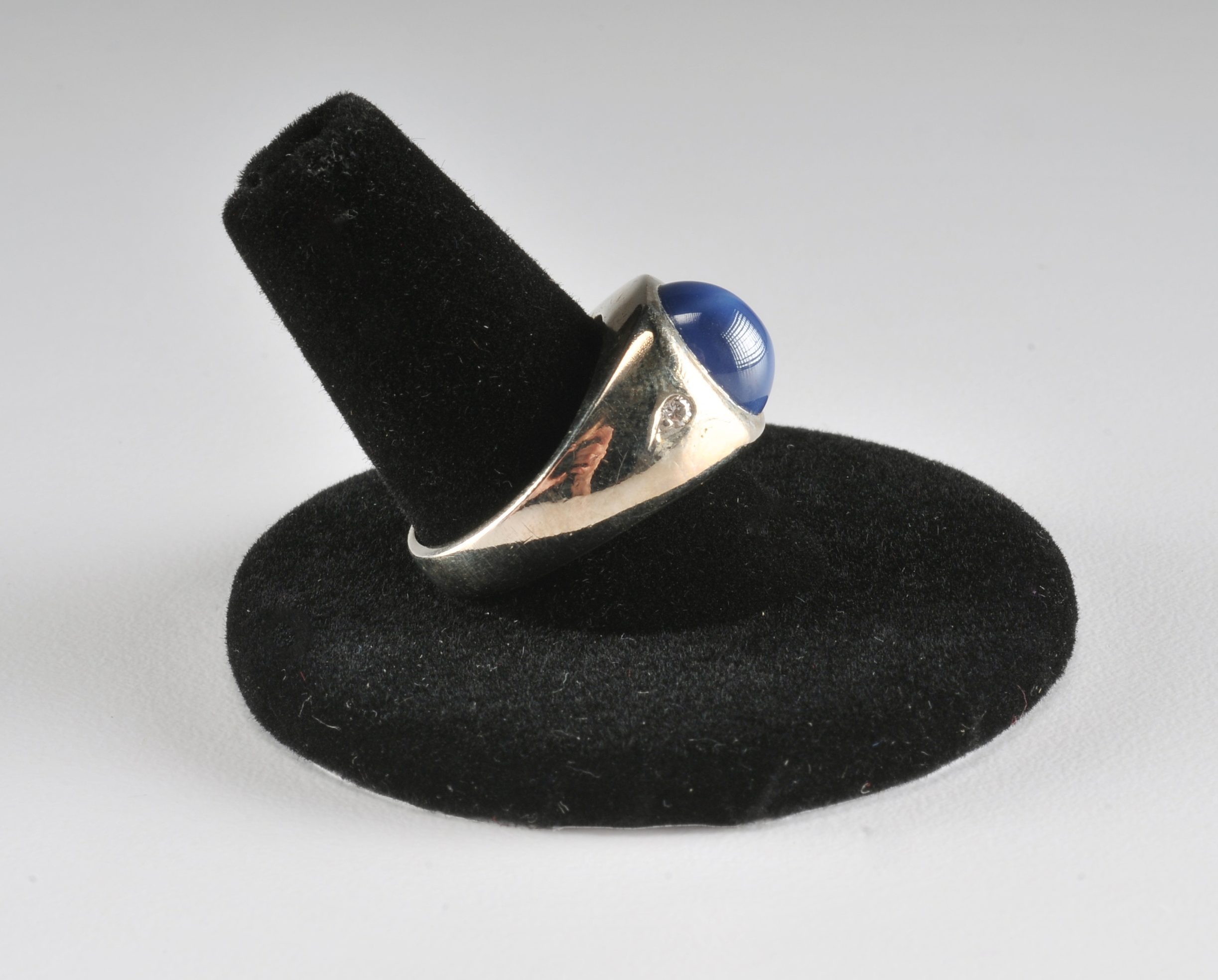 Ladies 14 K white gold ring with synthetic blue star sapphire and diamonds