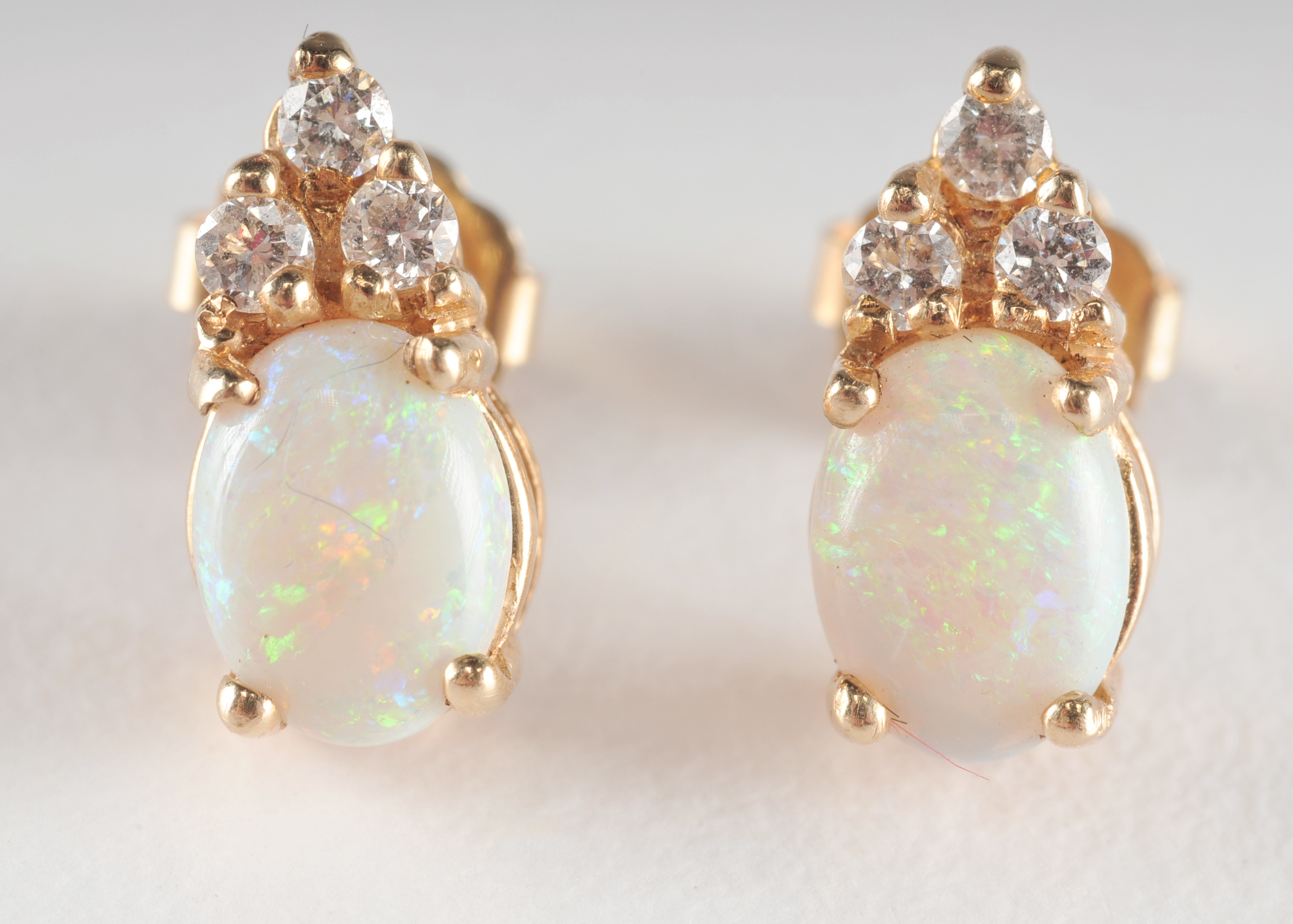 Pair of 14 K yellow gold opal and crystal earrings 