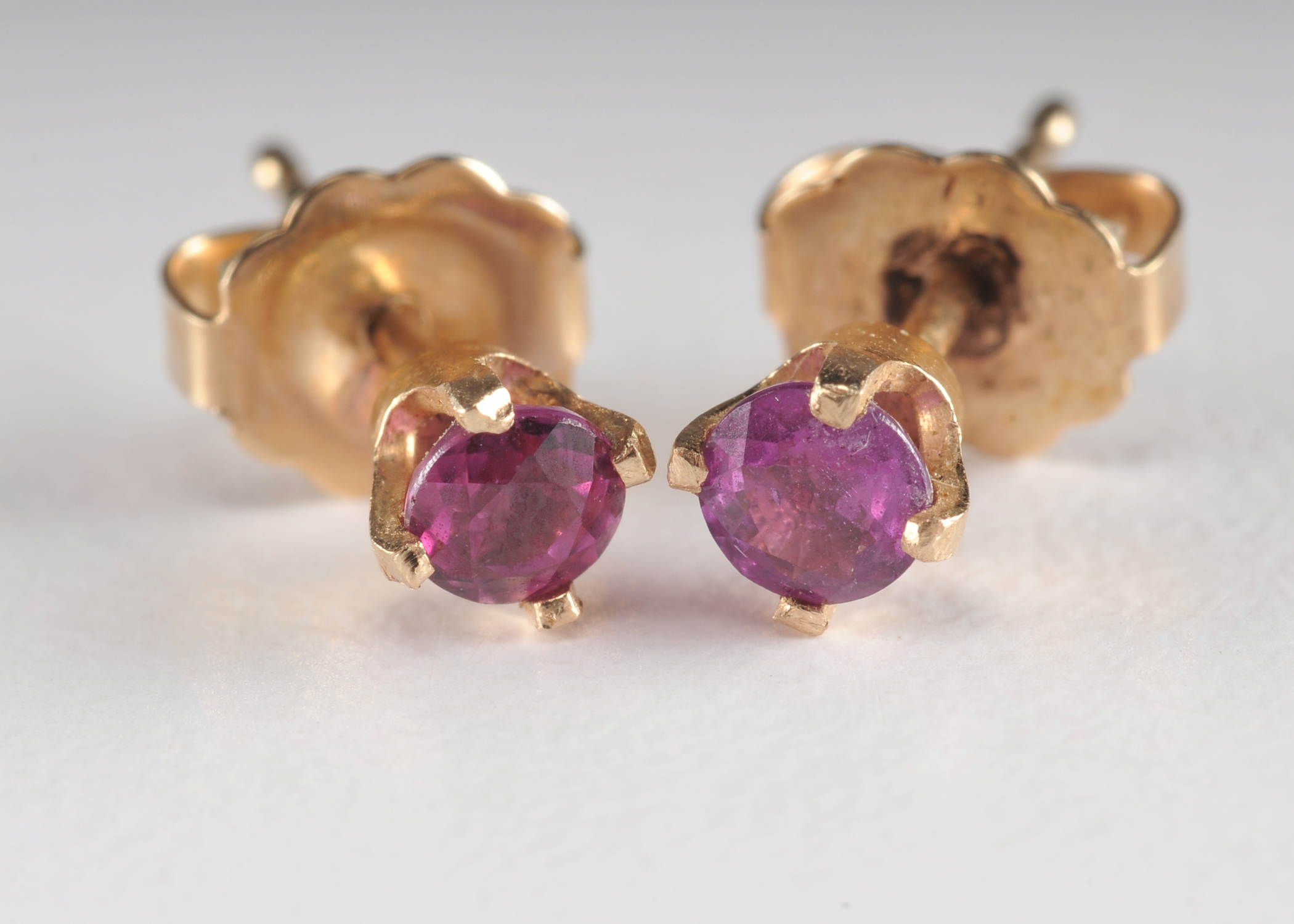 Pair of 14 K yellow gold and ruby post earrings 