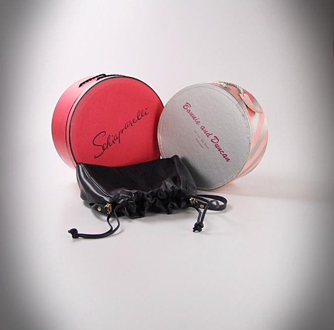 Two vintage hat boxes and a blue leather Etienne Aigner shoulderbag