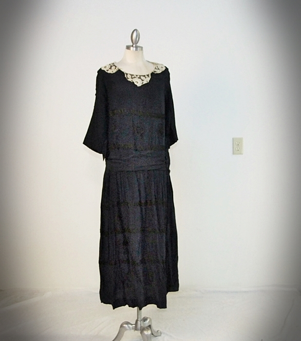 Early 20th Century black dress embellished with black hand embroidered silk and hand beaded jet black glass medallions