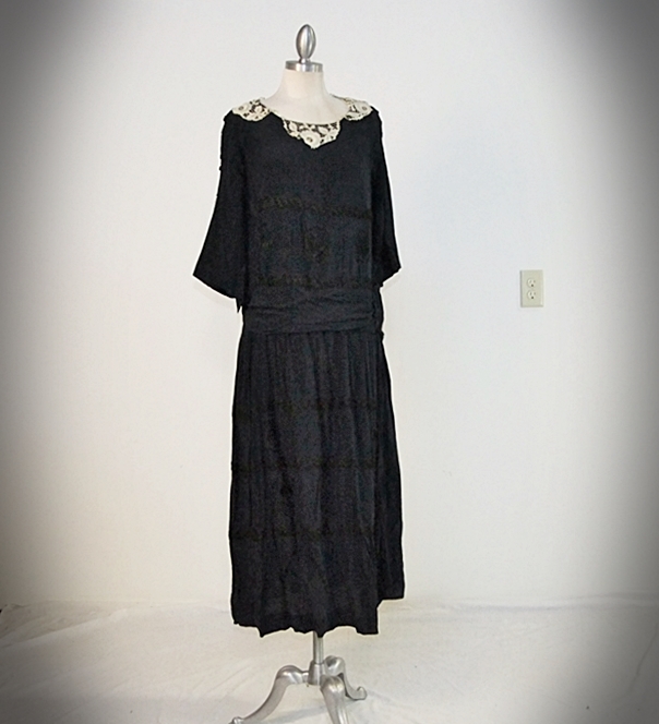 Early 20th Century black dress embellished with black hand embroidered silk and hand beaded jet black glass medallions