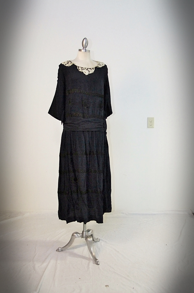Early 20th Century black dress embellished with black hand embroidered silk and hand beaded jet black glass medallions