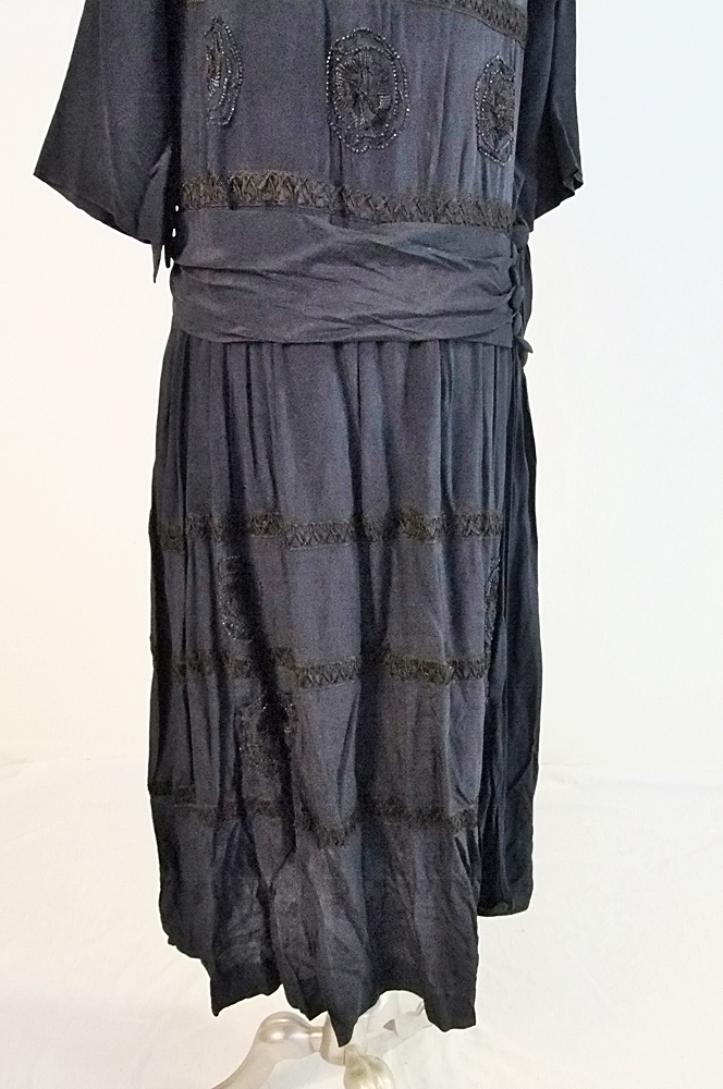 Early 20th Century black dress embellished with black hand embroidered silk and hand beaded jet black glass medallions