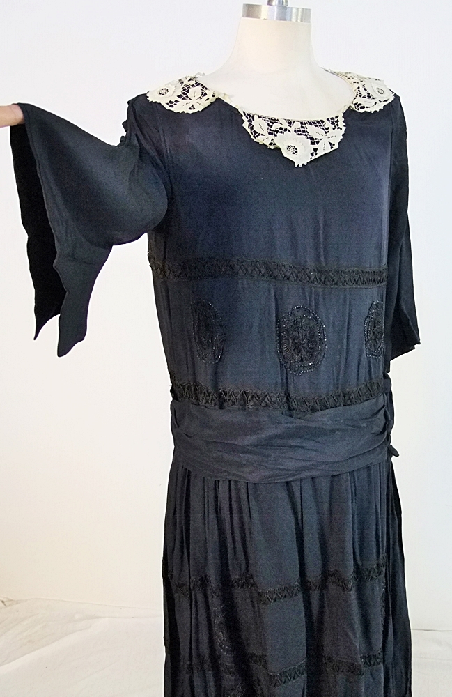 Early 20th Century black dress embellished with black hand embroidered silk and hand beaded jet black glass medallions