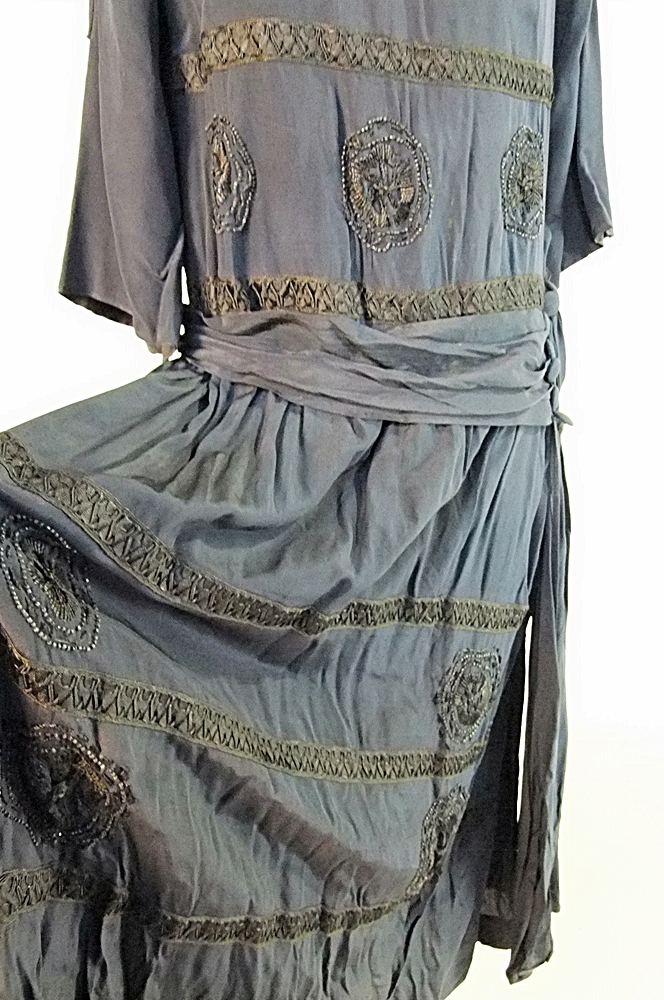 Early 20th Century black dress embellished with black hand embroidered silk and hand beaded jet black glass medallions