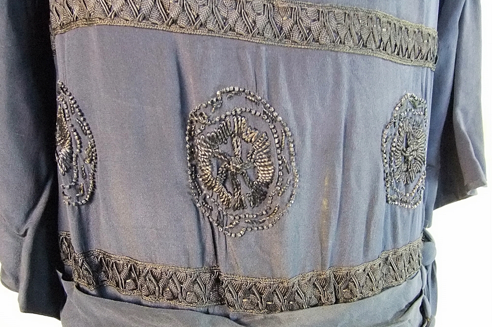 Early 20th Century black dress embellished with black hand embroidered silk and hand beaded jet black glass medallions