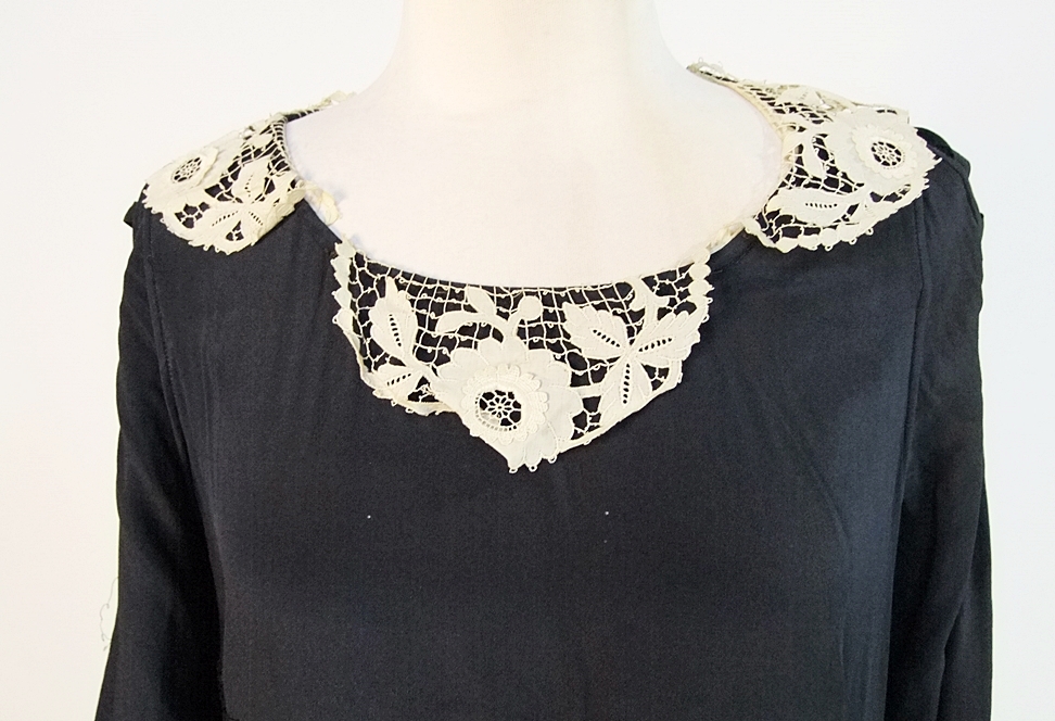 Early 20th Century black dress embellished with black hand embroidered silk and hand beaded jet black glass medallions