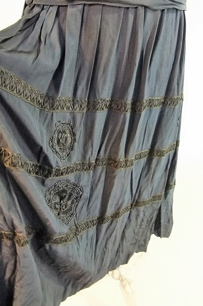 Early 20th Century black dress embellished with black hand embroidered silk and hand beaded jet black glass medallions