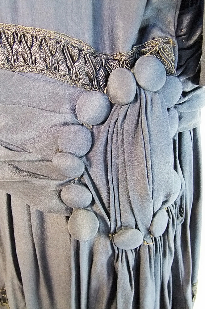 Early 20th Century black dress embellished with black hand embroidered silk and hand beaded jet black glass medallions