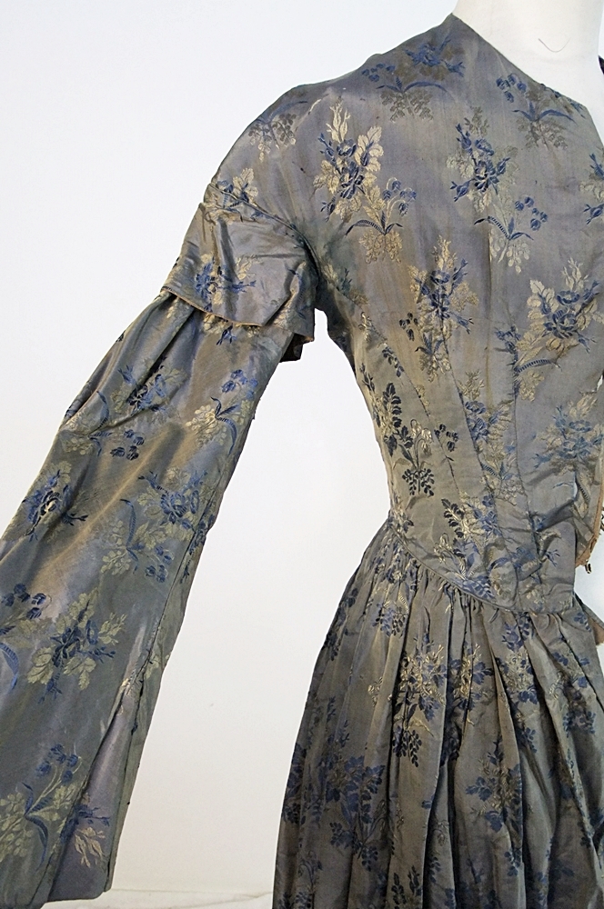 19th Century silk brocade gown in a slate blue gray with royal blue and cream floral sprays 