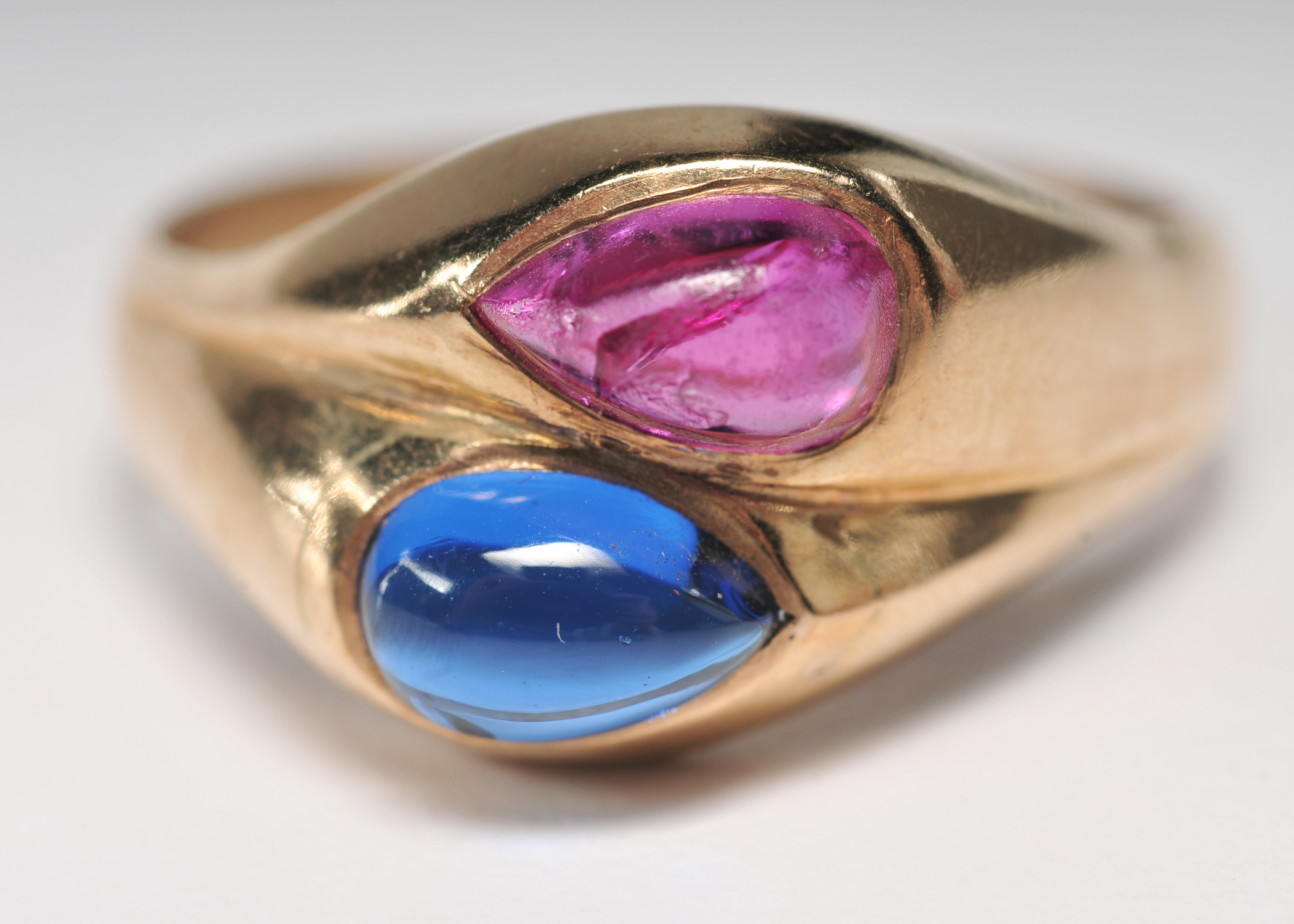 ladies 14 K yellow gold ring with blue and ruby pear shaped cabachons