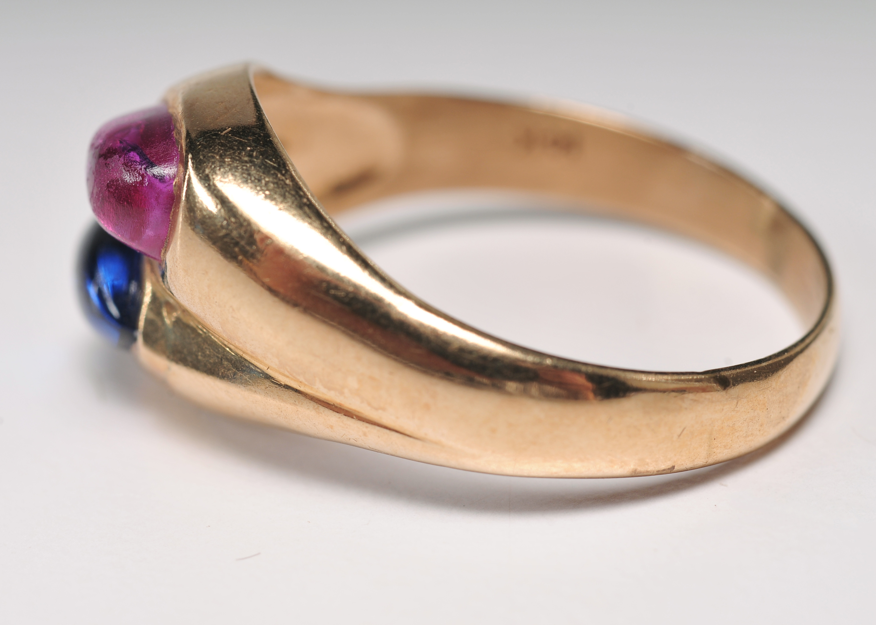 ladies 14 K yellow gold ring with blue and ruby pear shaped cabachons