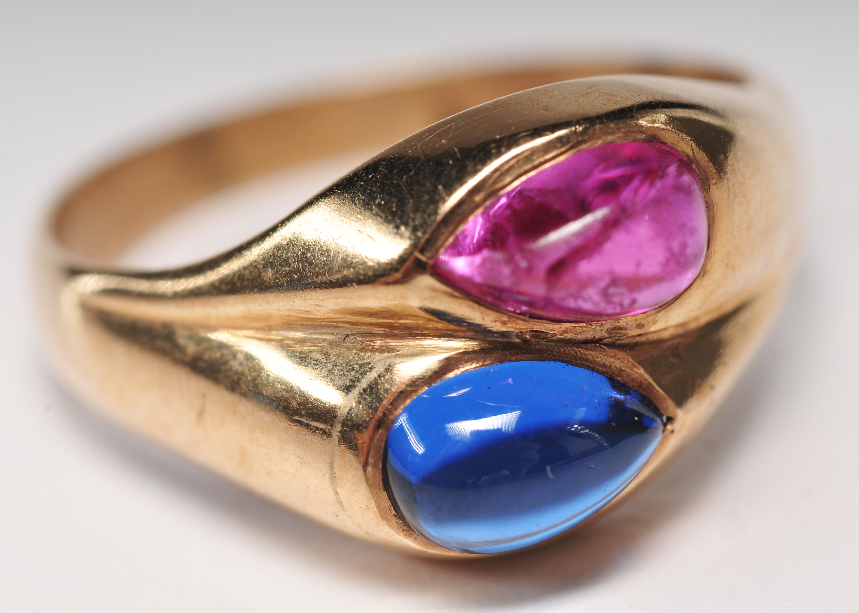 ladies 14 K yellow gold ring with blue and ruby pear shaped cabachons