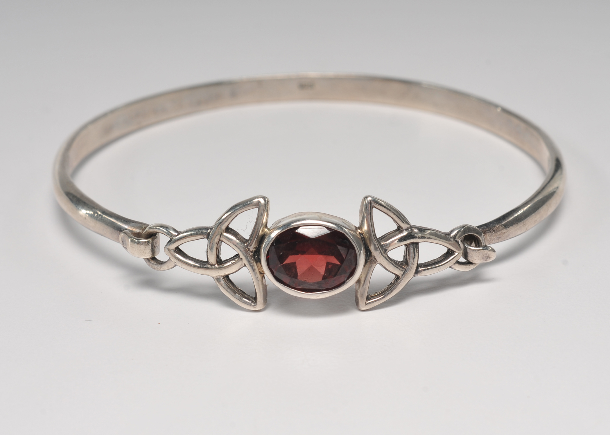Sterling silver bracelet with garnet and openwork Celtic knots 