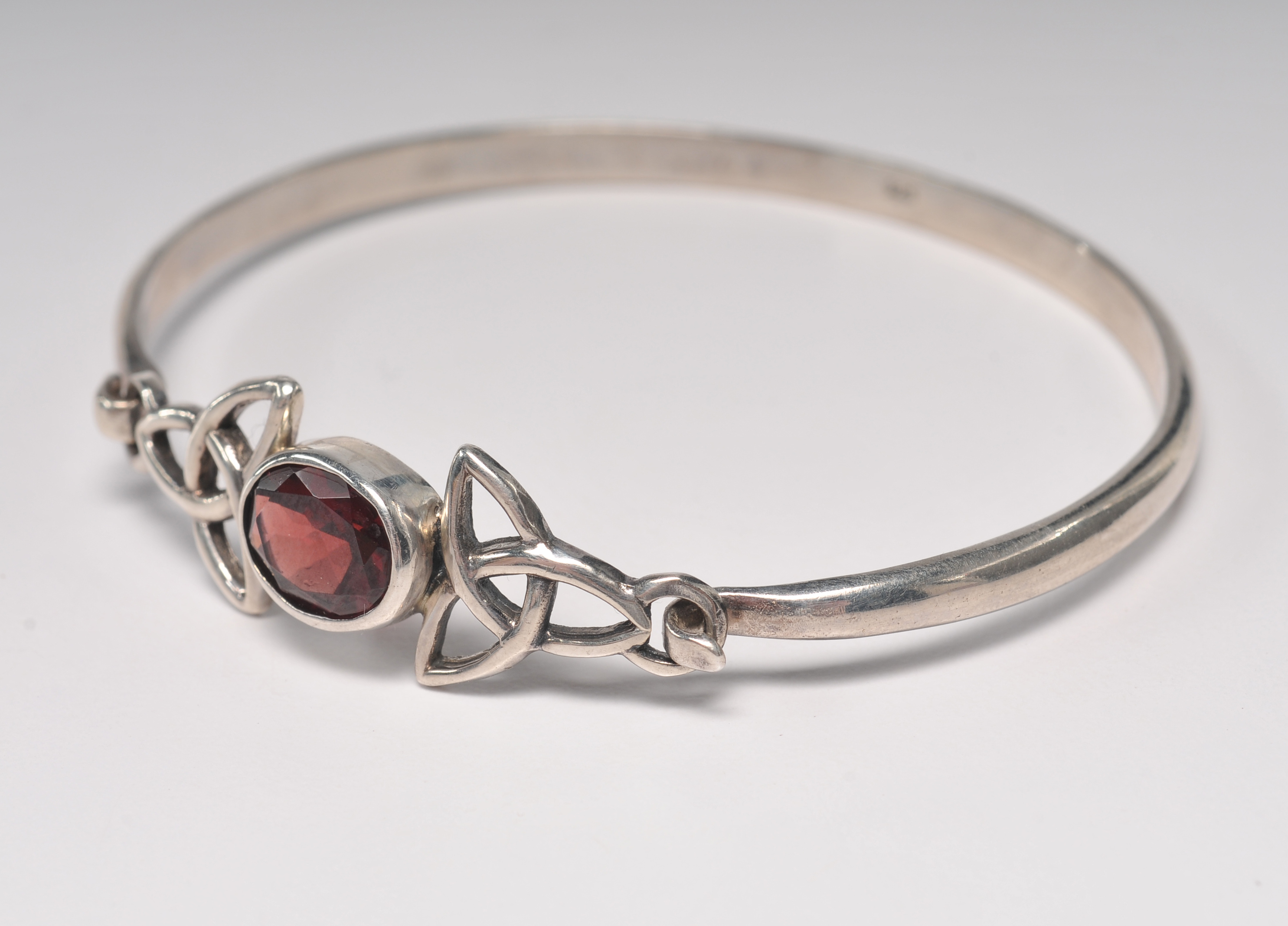 Sterling silver bracelet with garnet and openwork Celtic knots 