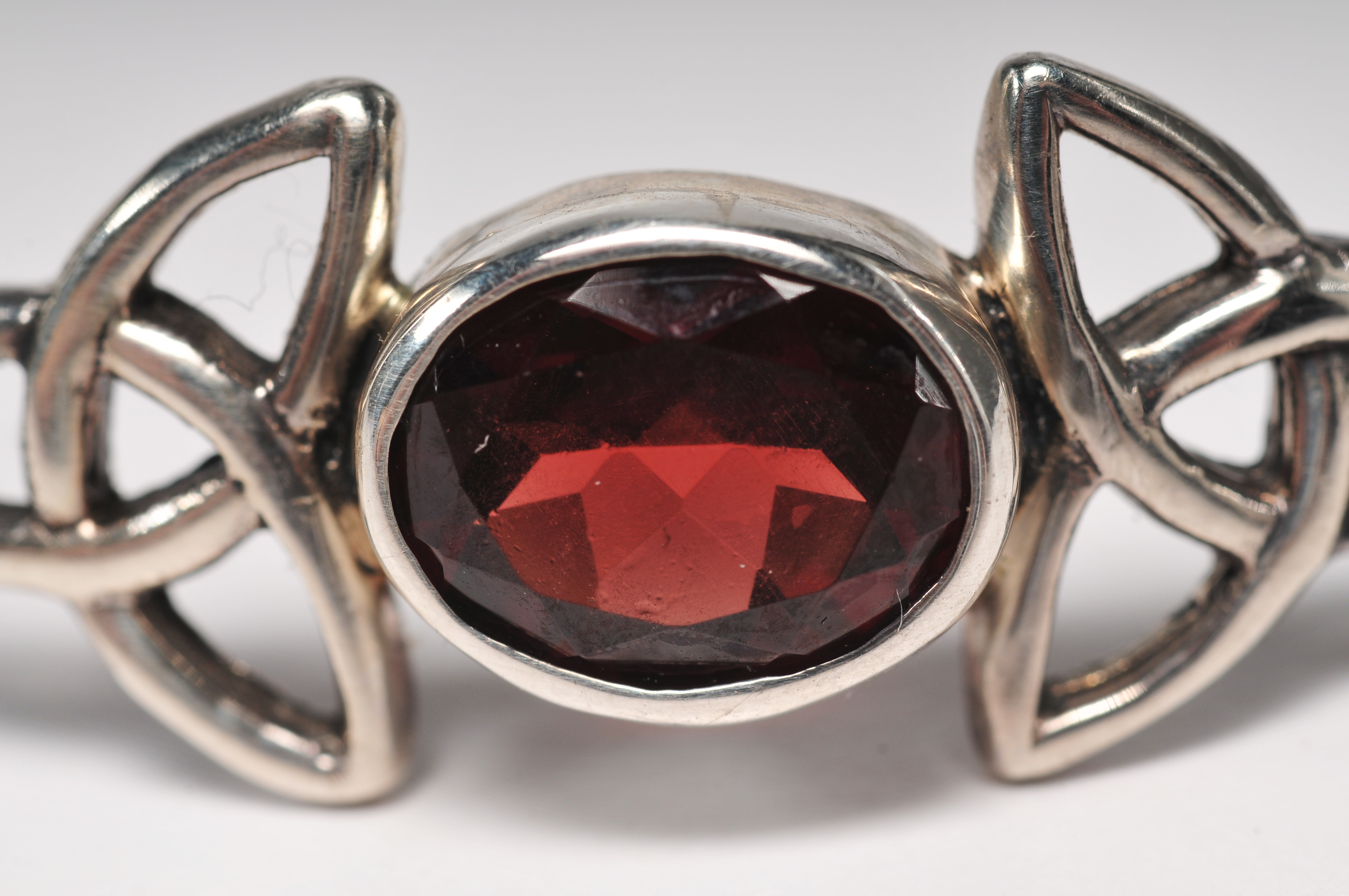 Sterling silver bracelet with garnet and openwork Celtic knots 