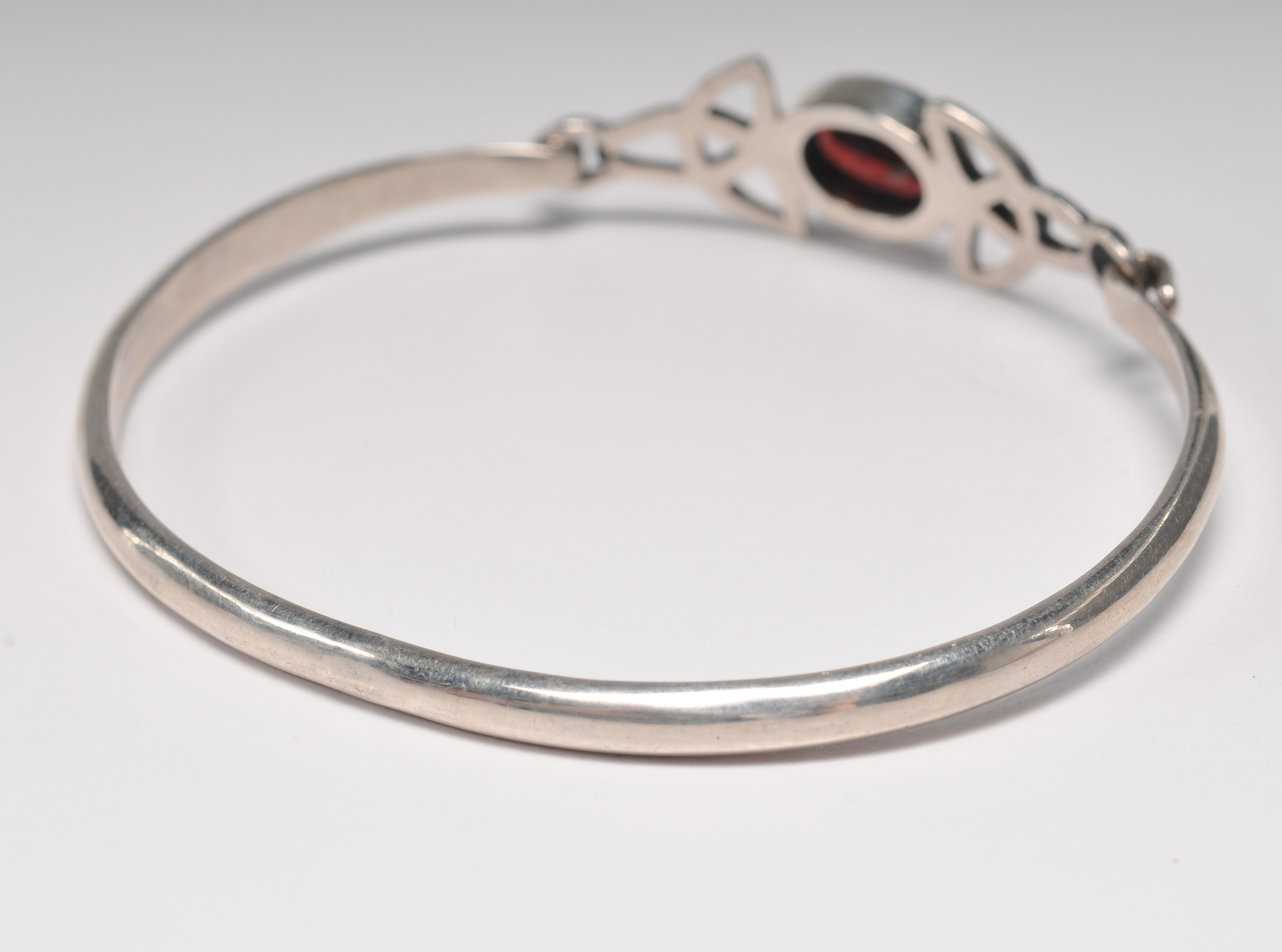 Sterling silver bracelet with garnet and openwork Celtic knots 